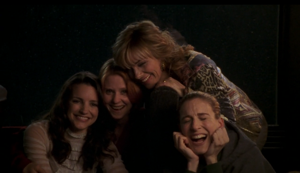Charlotte, Miranda, Carrie, and Samantha giggle together.