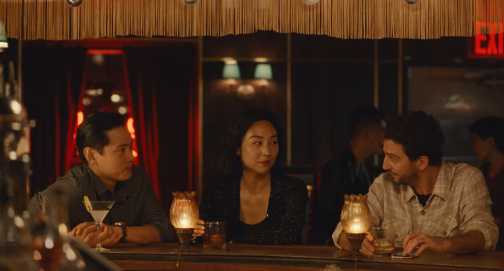 Hae Sung, Nora, and Arthur sit at a bar.